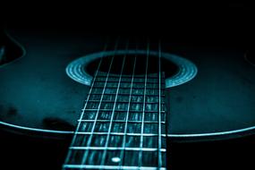guitar in green dark lighting close up