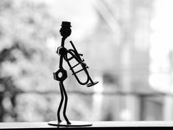 Black and white photo of tge Musician with Trumpet, Metal figurine