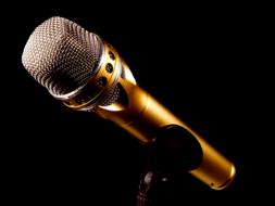 golden microphone on the black background