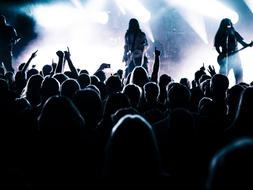 Crowd, on the concert of the band on the stage with lights