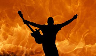 black silhouette of a rock guitarist on a background of flame