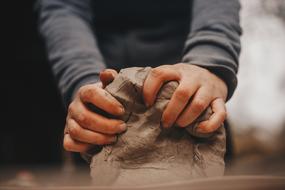 Hands of potter with clay