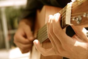 Guitar in hands of young boy