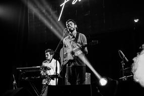 musicians on stage in black and white background