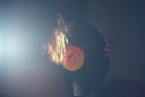 big vinyl record in hands in haze