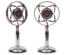 Two, shiny, metal wireless microphones, at white background