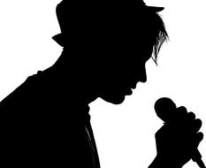 silhouette of a singer in a hat with a microphone