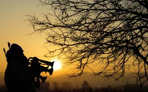 silhouette of a brass band at dawn