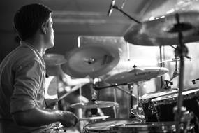 young boy plays on drum kit