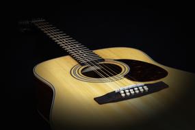 Wooden guitar in the shadow