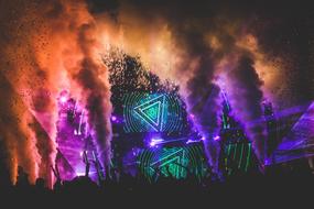 Silhouettes of the crowd, near the stage with the concert, with the colorful lights, in Mexico with the patterns