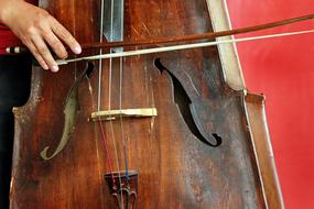 Person, playing on the beautiful, old, wooden cello