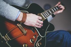 man playing guitar close-up