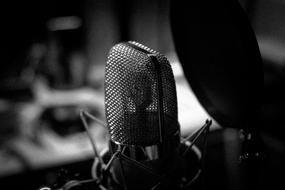 Black and white photo, with the close-up of the shiny microphone