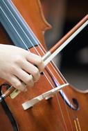 hand with bow at Violin strings