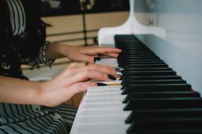 female hands on Piano keys