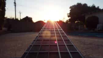 sunbeams on guitar fretboard