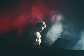 guy in smoke on stage during a concert