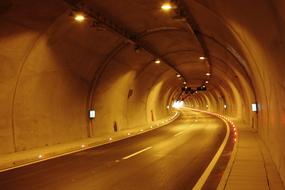 photo of concrete illuminated tunnel