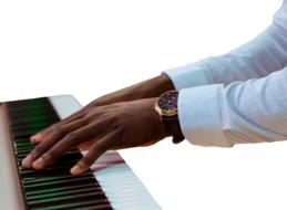 male hands with clock on piano keys