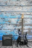 Electric Guitar at grunge wooden wall
