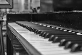 black and white photo of an old classic piano