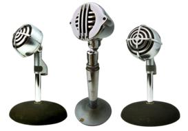 three vintage microphones in a radio studio
