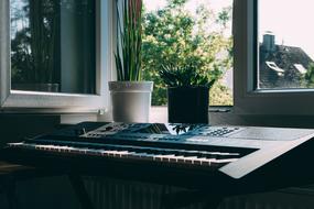 Keyboard of electric Musical instrument at open window