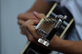 closeup view of playing on Guitar