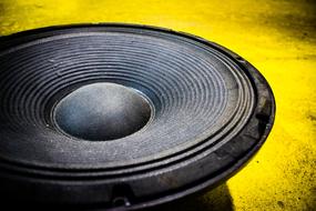 large audio speaker and yellow background