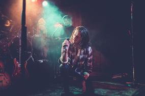 Singer on Concert, young man with microphone on stage