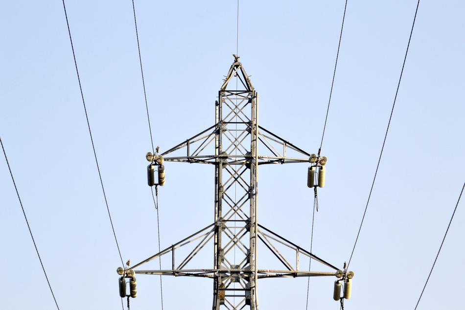 tower with power wires on the background of the sky