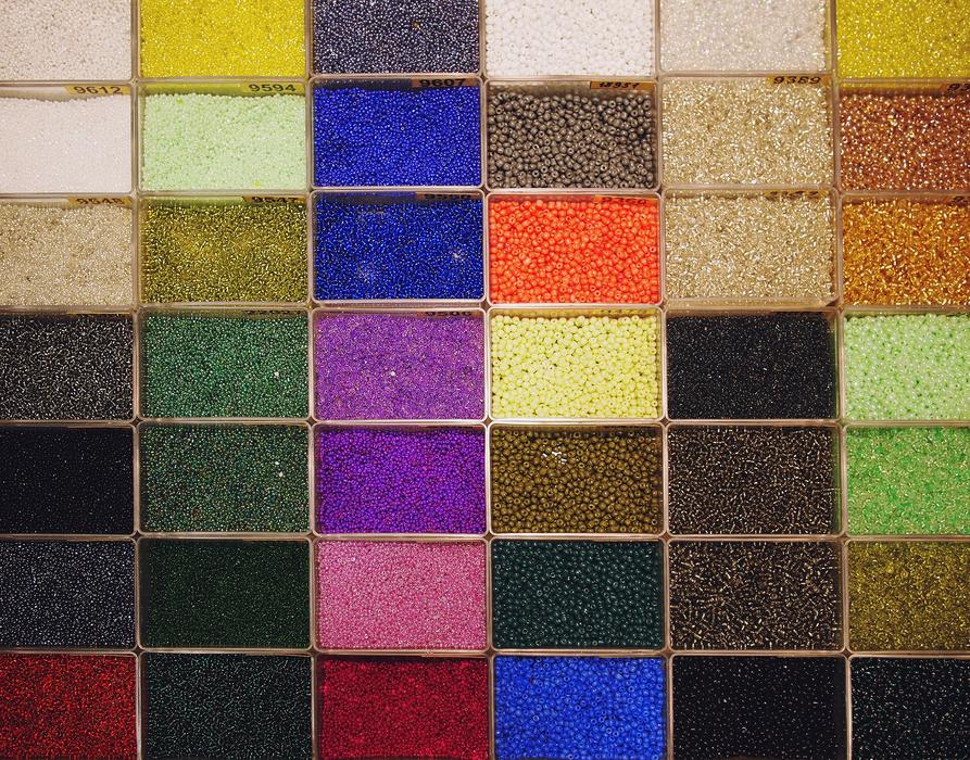 pearls of different colors in boxes
