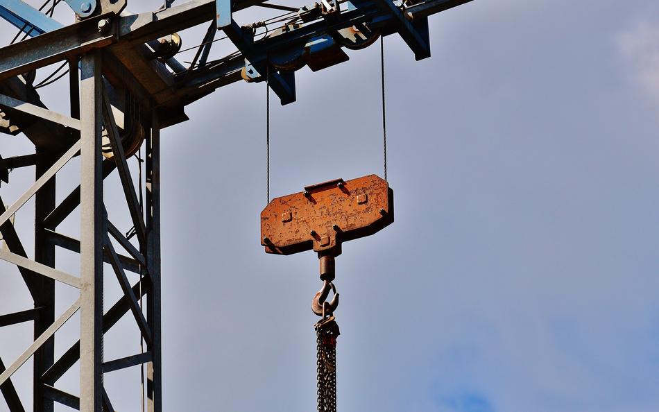 hook of tower crane with chains at sky