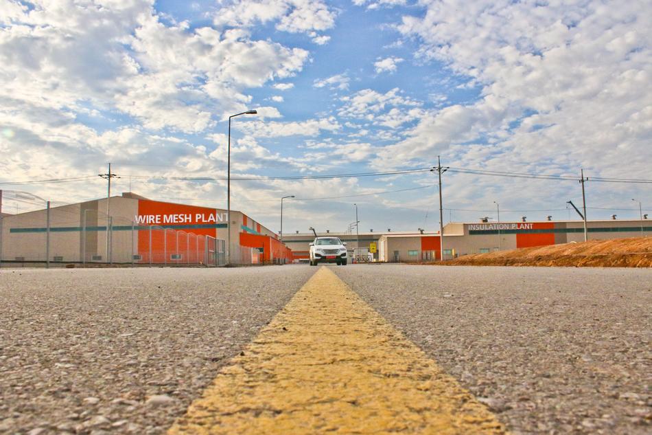 photo of a car on the road in the industrial zone
