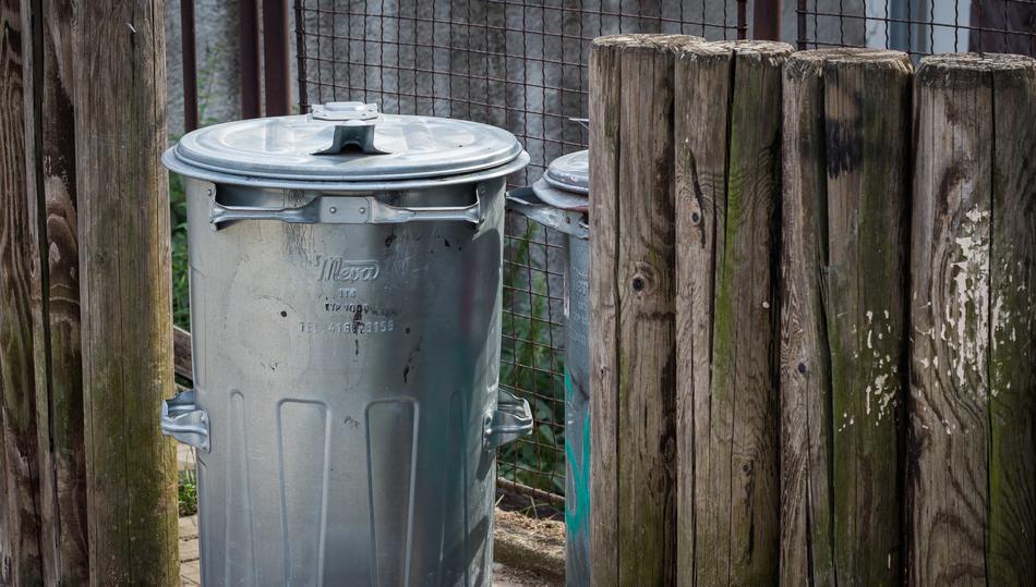 litter bin and wooden fence