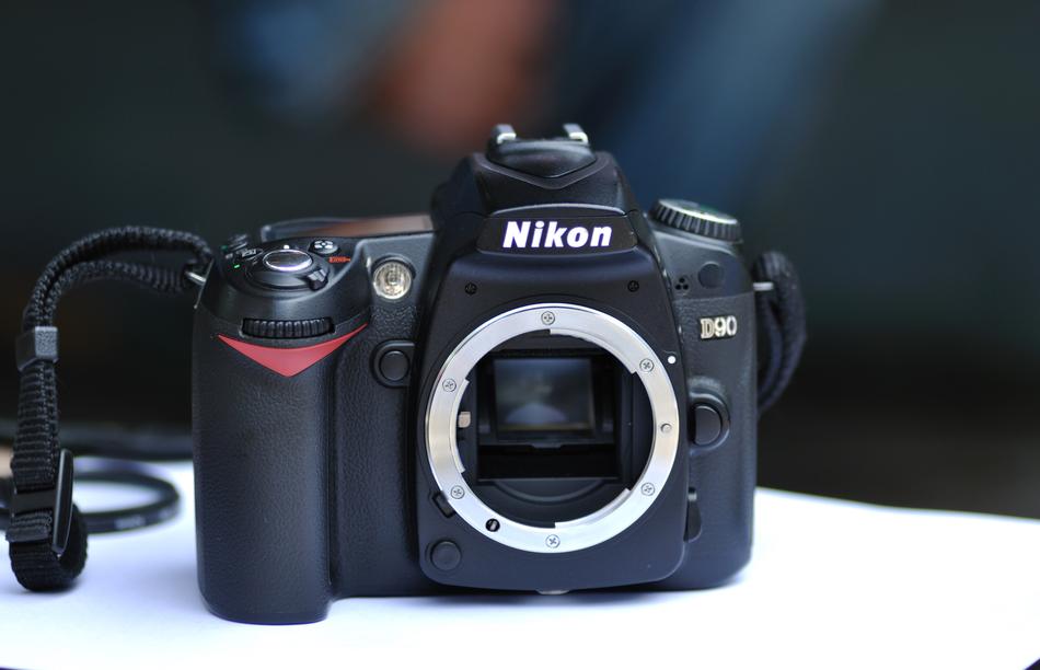 Beautiful, black and red Nikon camera, at blurred background