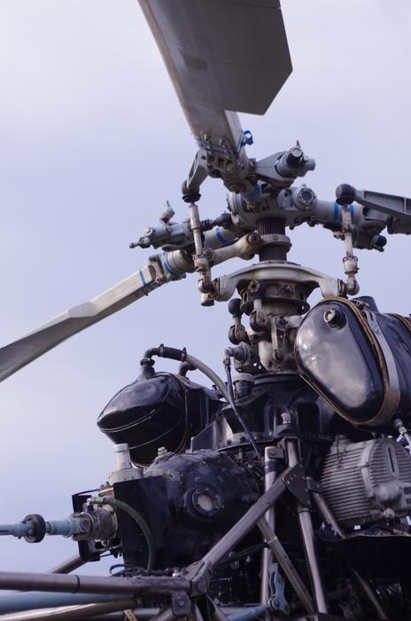 Close-up of the helicopter with the propellers and details, under the blue sky with white clouds