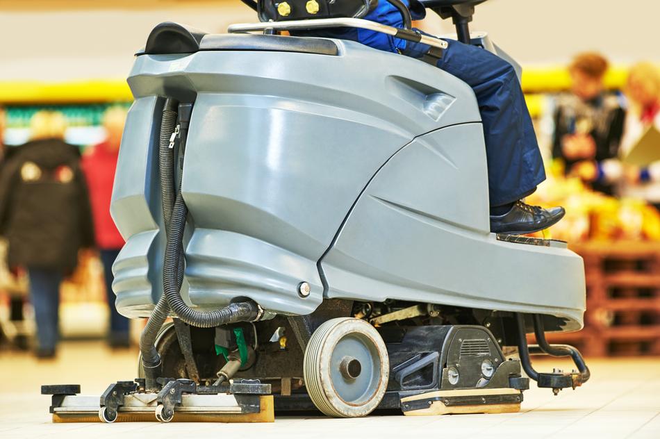 Person, on the floor cleaner machine, in the store