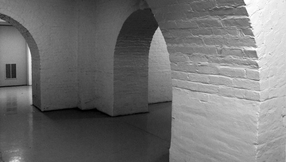 white brick corridor in the basement of the factor