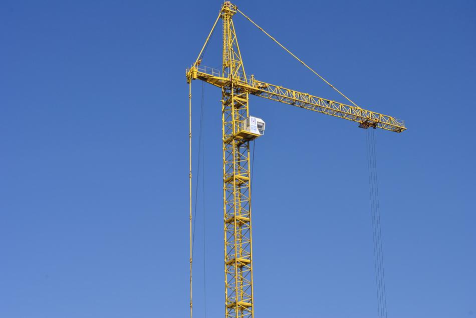 High, yellow tower at blue sky on background