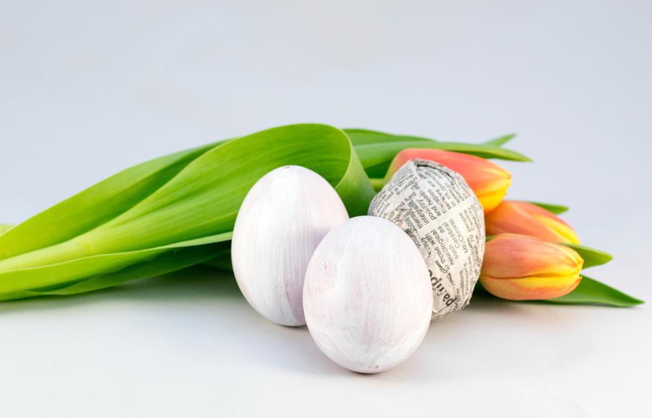 white eggs next to tulips