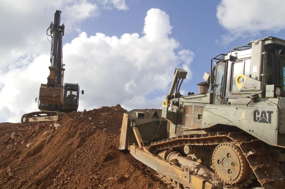 a pair of bulldozers at a construction site