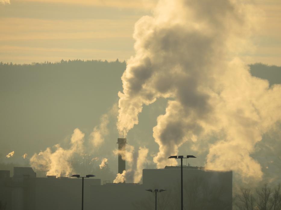 Landscape with the industrial plant, with the chimneys with smog at colorful sky on background
