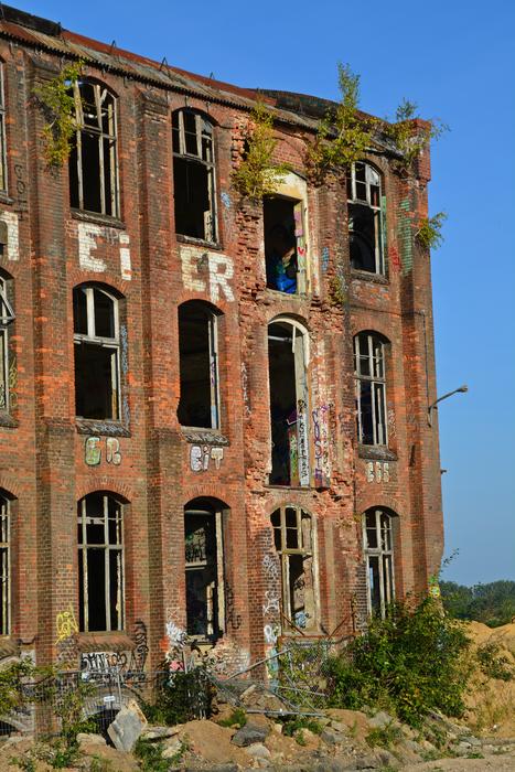 Beautiful, old, abandoned brick factory, among the green and yellow fields