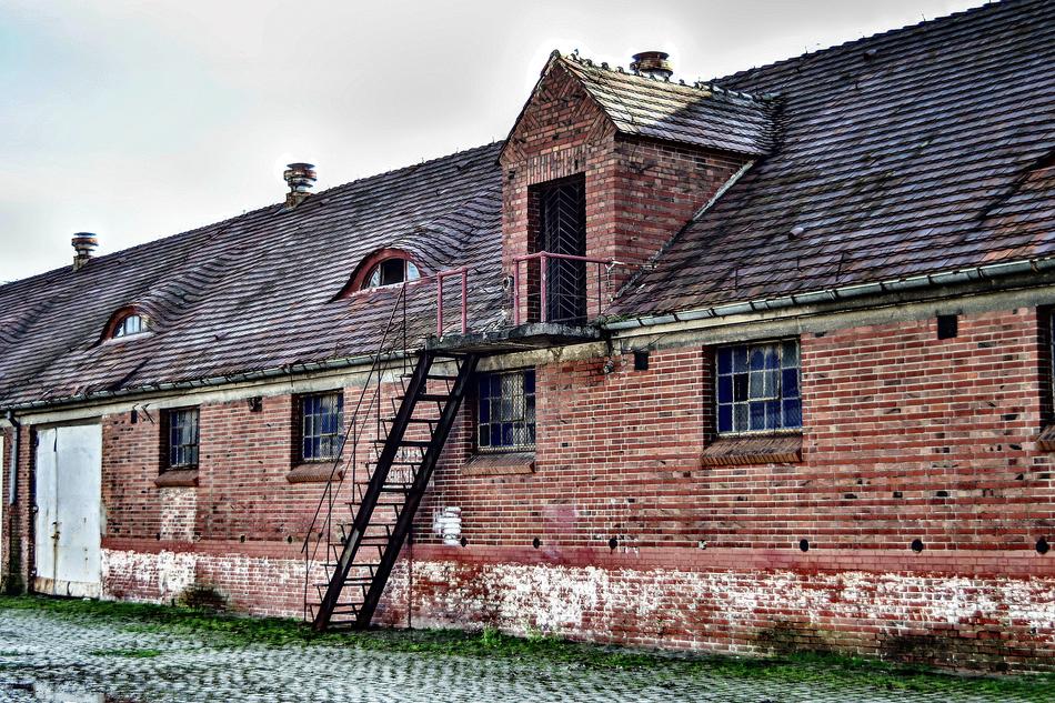 Beautiful, old and colorful brick building, with the stairs, at cloudy sky on background