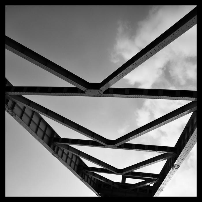black and white photo of steel beams against the sky