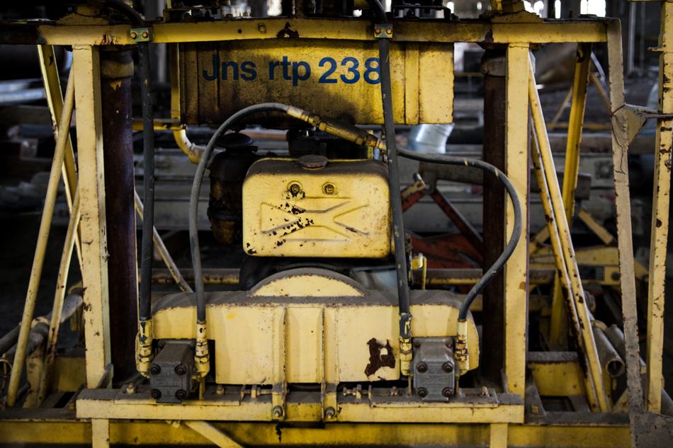 Yellow and black machinery, with the numbers and sign, in light
