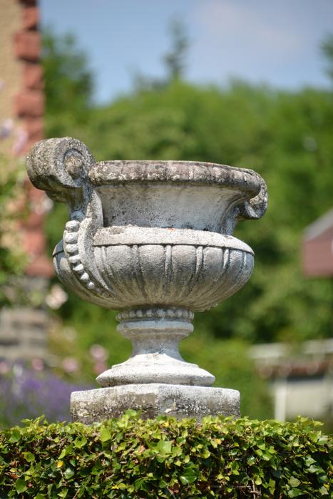 greek vessel in the garden on a blurred background