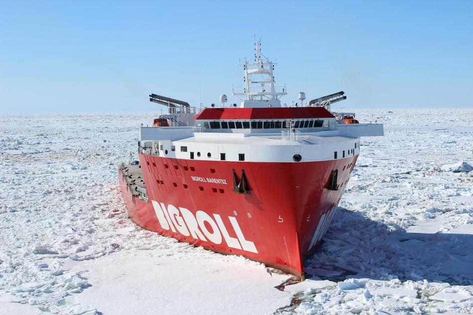 Red and white Bigroll Barentsz, among the beautiful, white ice, at blue sky on background